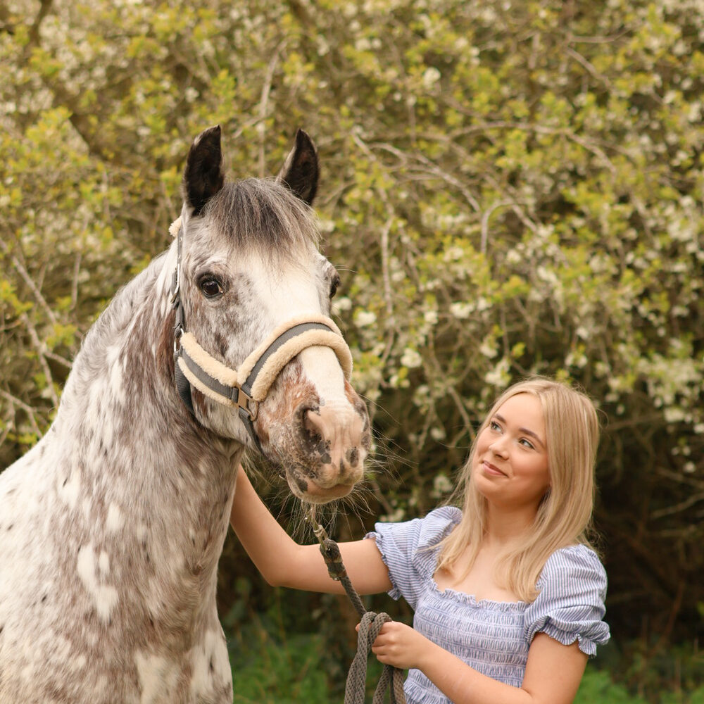 Young rider with a grey pony